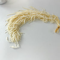 Preserved ivory amaranthus used to decorate a wedding arch and event backdrop.